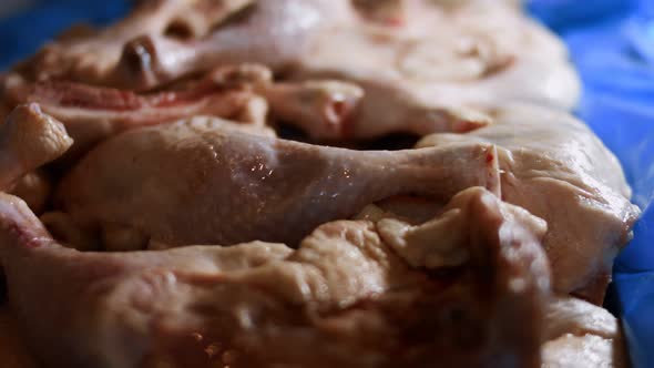 Closeup View of a Box Full of Frozen Chicken Legs alt
