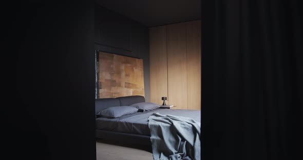 The Modern Bedroom with Black Tone Large Paintings and Brown Wooden Wardrobe alt