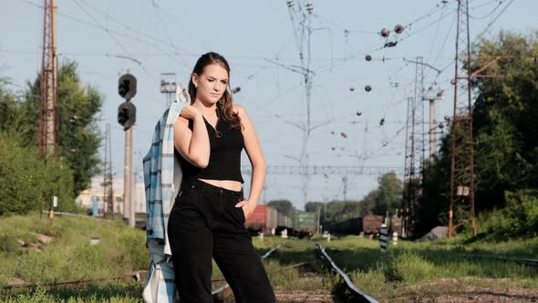 Young Sexy Woman Stands on the Train Tracks and Looks at the Camera alt