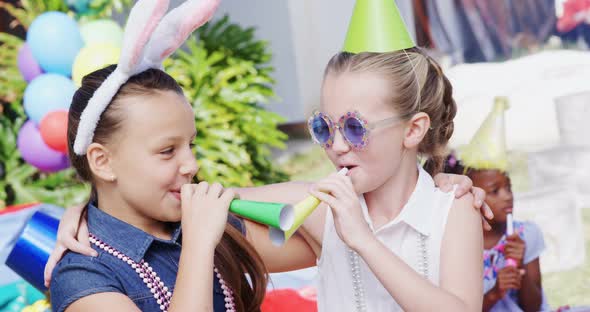 Happy girls blowing party horn 4k alt
