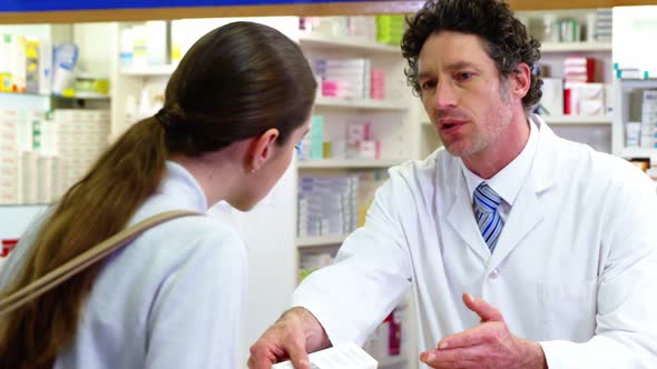 Pharmacist assisting the medicine to customer alt