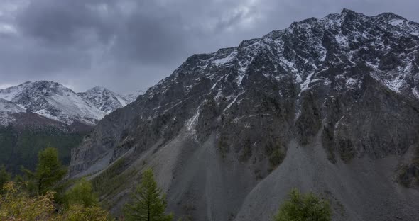 Timelapse of Epic Clouds in Mountain Valley Autumn Time. Wild Endless Nature and Snow Storm Sky Over alt
