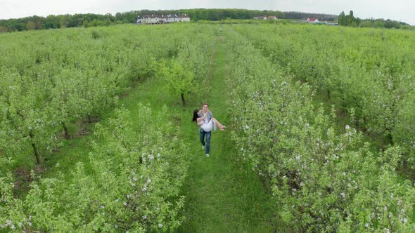 Drone View of Groom Carrying Beloved Bride in Arms alt