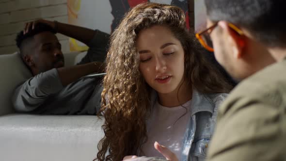 Girl Demonstrating Colour Samples to Colleagues alt
