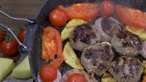 Grill pan with meatballs and vegetables 