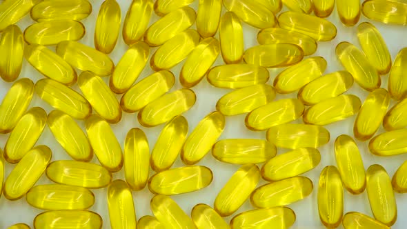 Vertical orientation video: Omega 3 (fish oil). Organic supplements vitamins yellow capsules