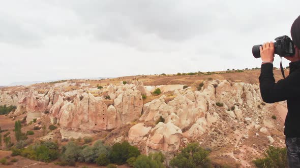 Woman Photographing Scenic Landscape alt