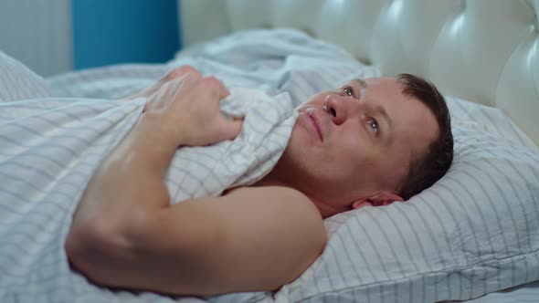 Man Dreaming While Lying in Bed Before Going To Bed, Camera Movement alt