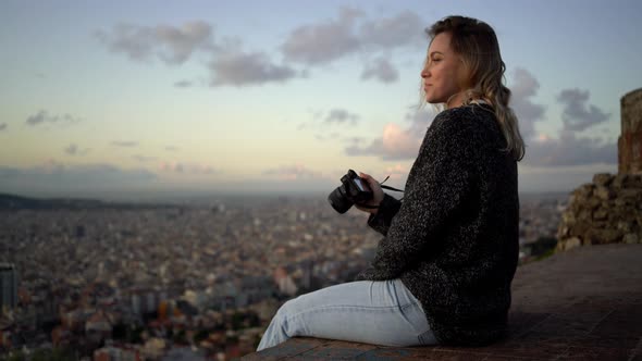 Portrait of female photographer with city in background alt