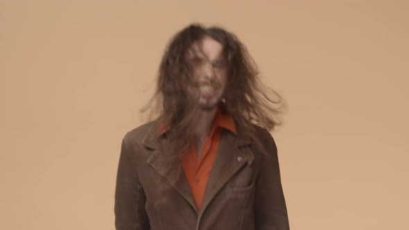 Wild and Free Enthusiastic Young Man with Beard in Brown Blazer Rocknroll Heavy Metal Fan Whip Hair alt