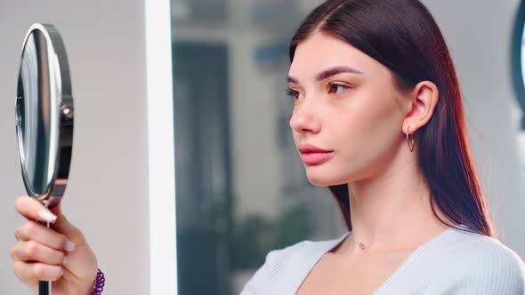 Permanent Makeup Master Prepares Woman Client for Eyebrow Microblading Procedure alt