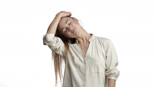 Young Sensual Woman in Beige Blouse Whip Her Hair and Combing It with Fingers Standing Flirty alt