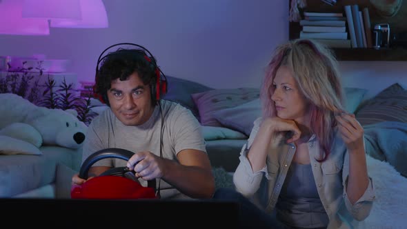 couple relations at evening home, computer video games