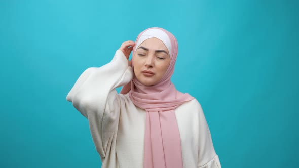 Young Muslim Woman in Hijab Posing Isolated on Blue Background Studio