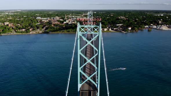 Aerial footage approaching the Ambassador Bridge in Detroit, Michigan at sunset alt