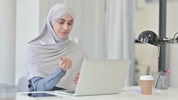 Young Arab Woman with Laptop Having Wrist Pain alt