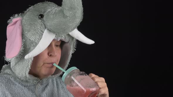 Closeup Shot of a Lady in an Elephant Costume Drinking a Smoothie