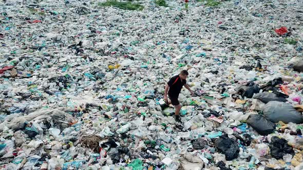 A man at a landfill. The concept of environmental pollution and environmental catastrophe. alt