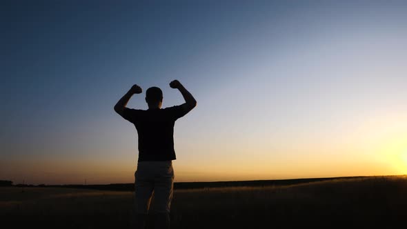 Confident man raising hands up in the air. People success, victory, and power.