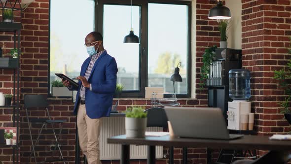 Office Consultant Waiting Around in Startup Office Using Digital Tablet alt