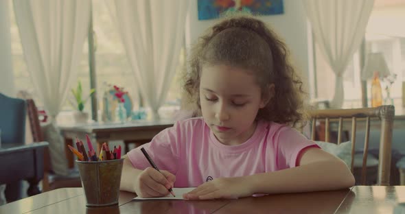 Happy Little Girl or Cute Primary Child School Child of 78 Years Old at Home Relaxing Sits in House alt