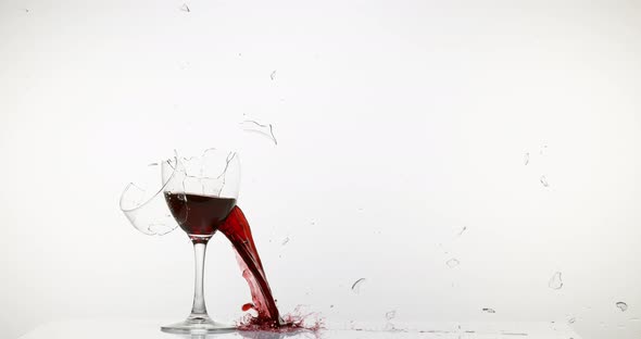 900130 Glass of Red Wine Breaking and Splashing against White Background, Slow motion 4K alt