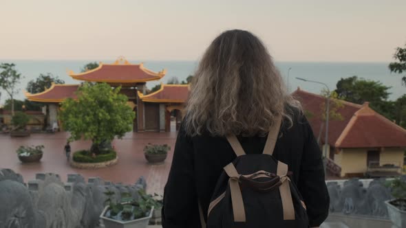 Tourist Woman is Visiting Truc Lam Ho Quoc Zen Monastery in Vietnam alt