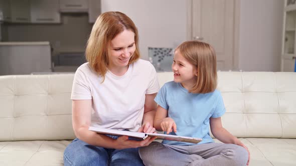 Mother and Daughter Watch Photobook Family Photo Shoot in Spring Garden alt