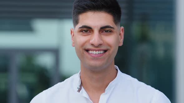 Human Male Face Smiling Indian Guy Looks at Camera alt