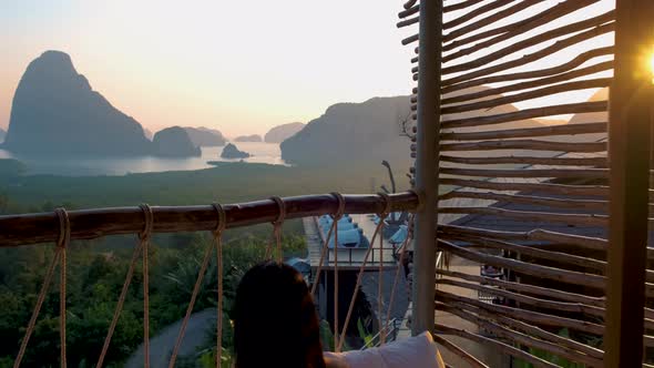 Woman Mid Age on Vacation in Thailand Waking Up in the Jungle with Bedroom Outside Watching Sunrise alt