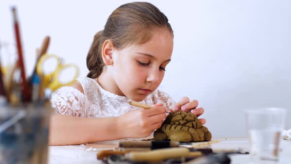 Portrait of Kid Girl is Modeling Toys From Clay