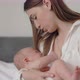 Mother Caressing Crying Newborn Son on Hands - VideoHive Item for Sale