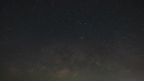 Milky Way galaxy exploration through outer space towards glowing milky way galaxy. Night to Day alt