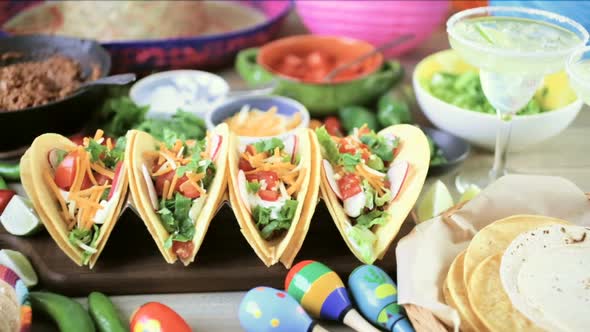 Ground beef tacos with romaine lettuce, diced tomatoes, radishes, and shredded cheddar cheese. alt