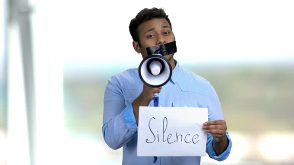 Man with Tape on Mouth Holding Megaphone alt