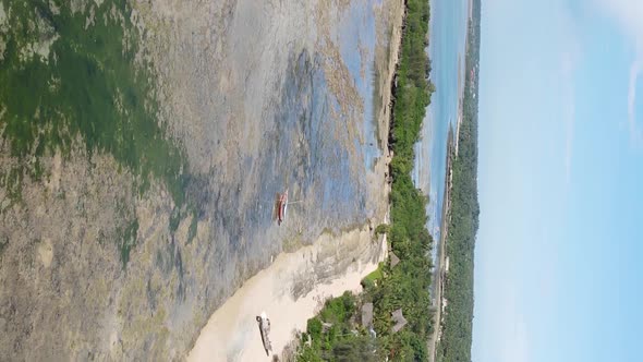 Vertical Video of Low Tide in the Ocean Near the Coast of Zanzibar Tanzania Aerial View alt