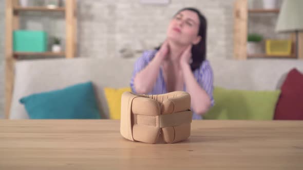 Collar From Neck Pain and in the Background a Young Woman with Neck Pain