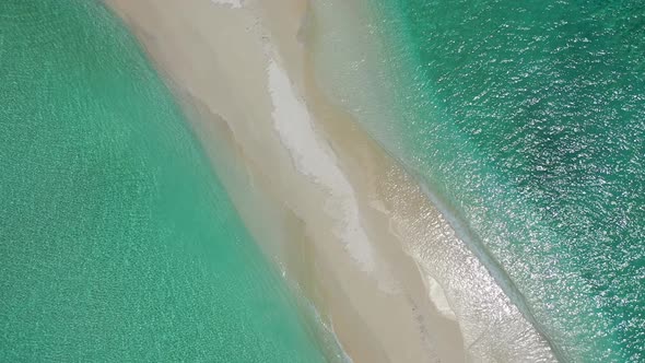 Tropical drone tourism shot of a white sand paradise beach and blue sea background  alt