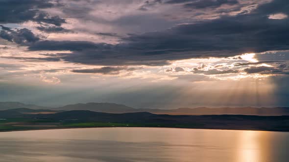 Time lapse of sun rays beaming through the clouds over Utah Lake alt