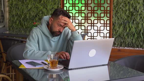 Man Feeling Worried with Laptop