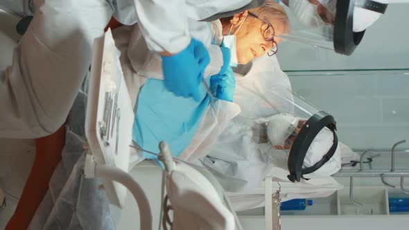 Vertical Video Dentist with Medical Overall Checking Patient Dental Problem alt