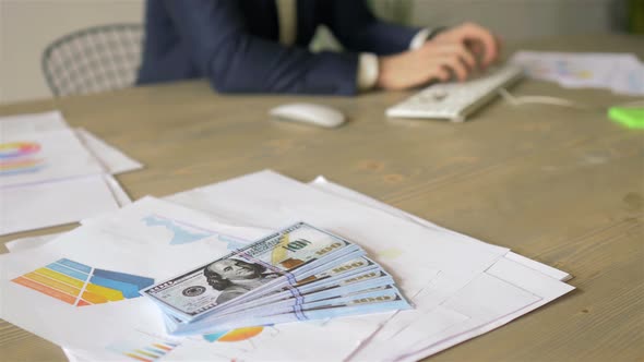 close up a bundle of money is on paper with graphs