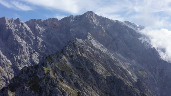 Panoramic Aerial Shot of the Lauskopf Mountains with Blue Sky in Background alt