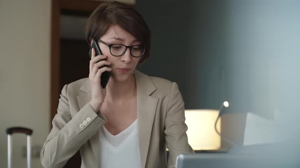 Female Business Traveler Working from Hotel Room alt