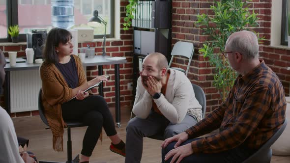 Person Having Anger Crisis in Front of People at Aa Group Therapy Meeting alt