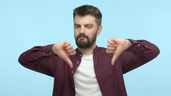 Attractive Guy with Beard Wearing Red Shirt Over Tshirt Judging Bad Offer Shaking Head and Showing
