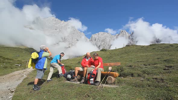 Four Hikers in Mountains Resting