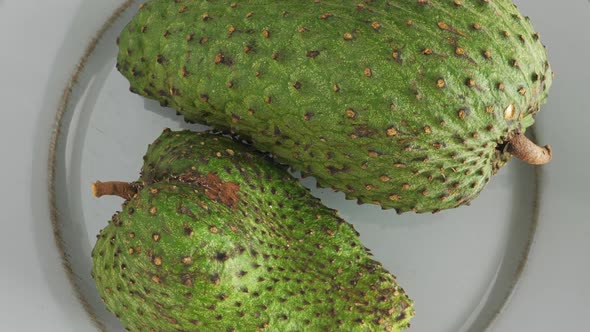 Closeup of Green Soursop Graviola, Exotic, Tropical Fruit Guanabana on Plate alt
