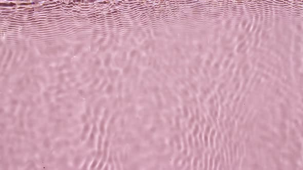 Pure Pink Water with Reflections Sunlight in Slow Motion alt