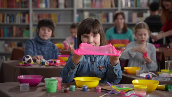 Preteen Autistic Girl Stretching Slime on Camera alt